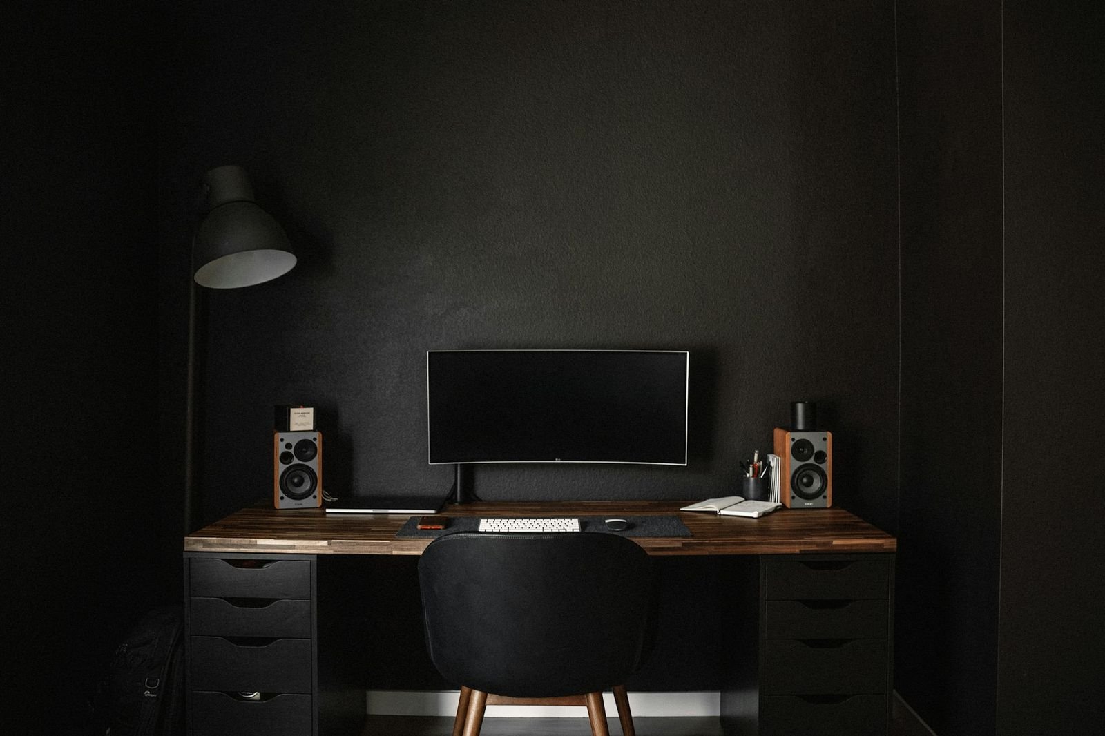A dark, minimal studio workspace
